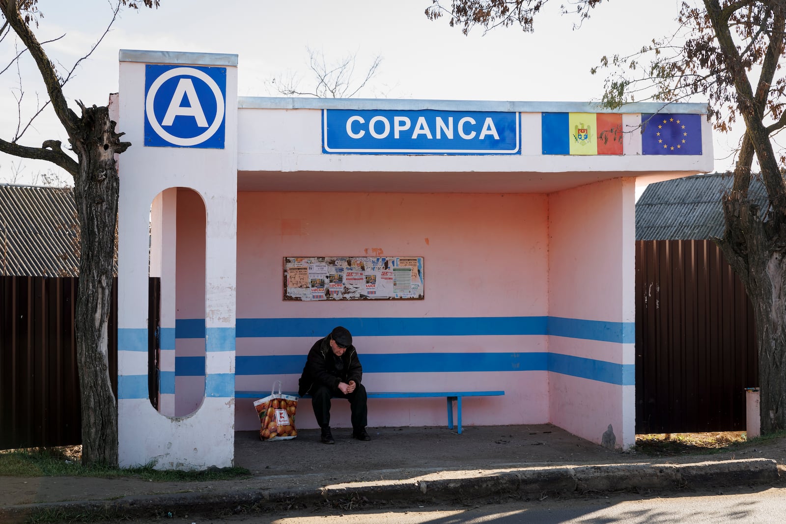 A man waits at a bus stop in Copanca, Moldova, Wednesday, Jan. 8, 2025. (AP Photo)