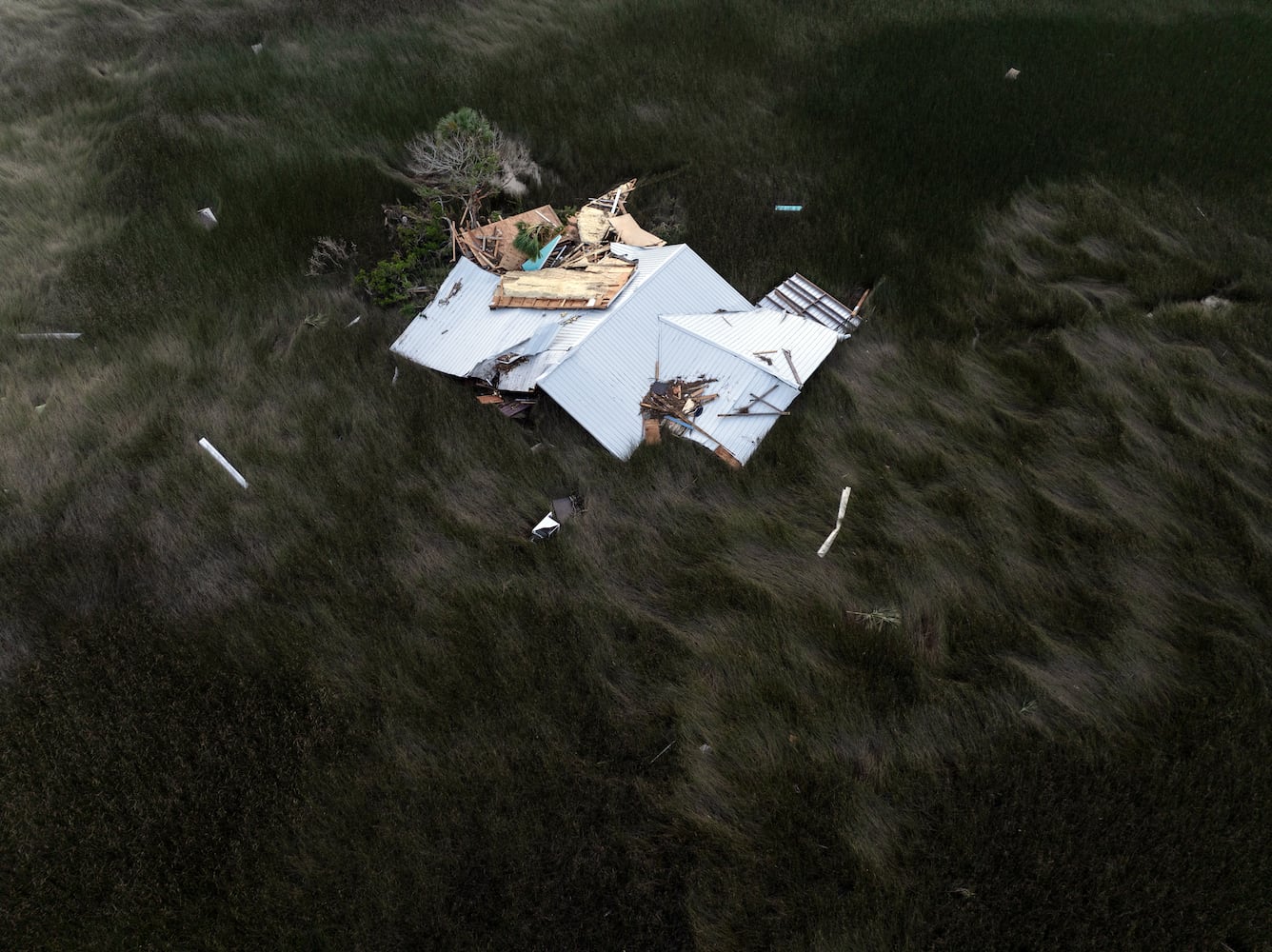 A roof blown away by Hurricane Helene lies in a tidal marsh near the Gulf Coast community of Keaton Beach, Fla., on Saturday, Sept. 28, 2024. (Paul Ratje/The New York Times)