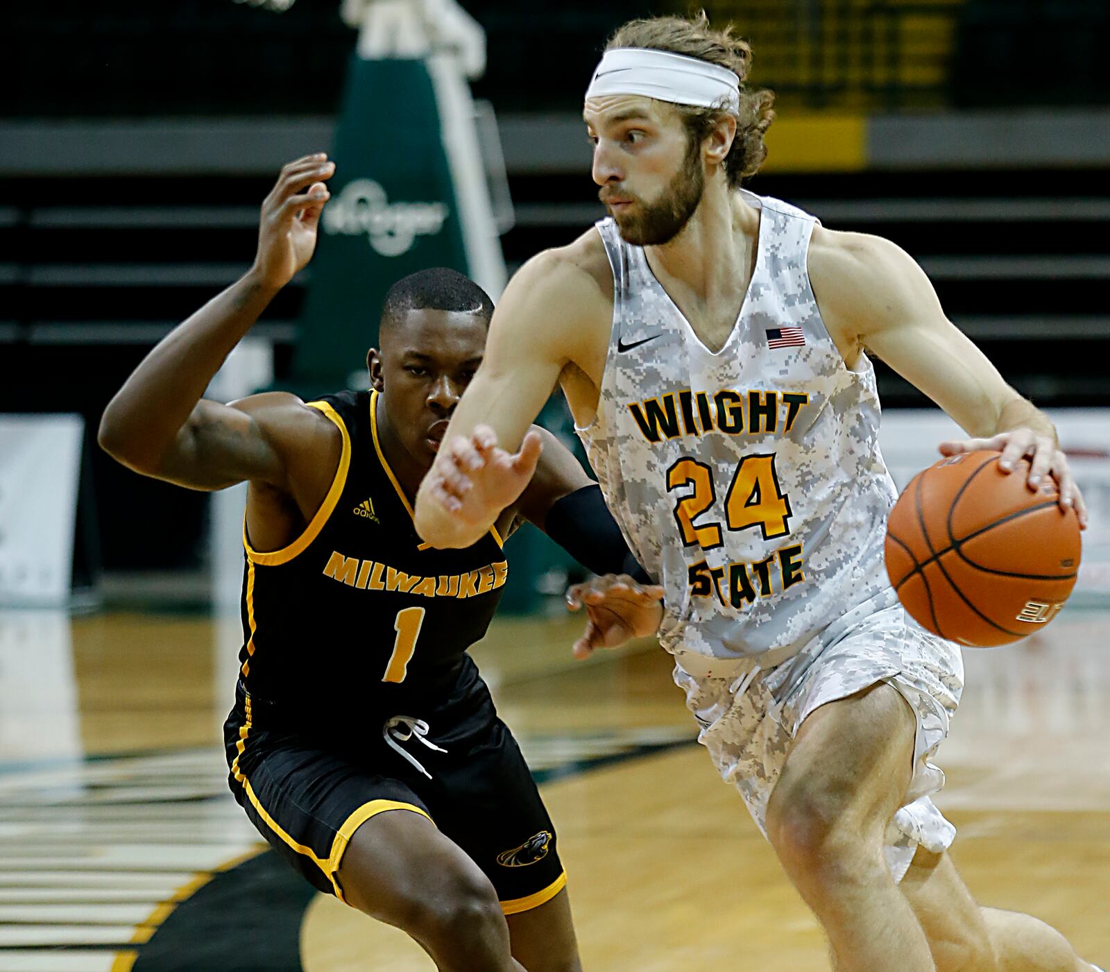 Wright State guard Tim Finke drives to the paint on Milwaukee guard Devon Hancock during a Horizon League quarterfinal at the Nutter Center in Fairborn Mar. 2, 2021. Wright State lost 94-92. E.L. Hubbard/CONTRIBUTED