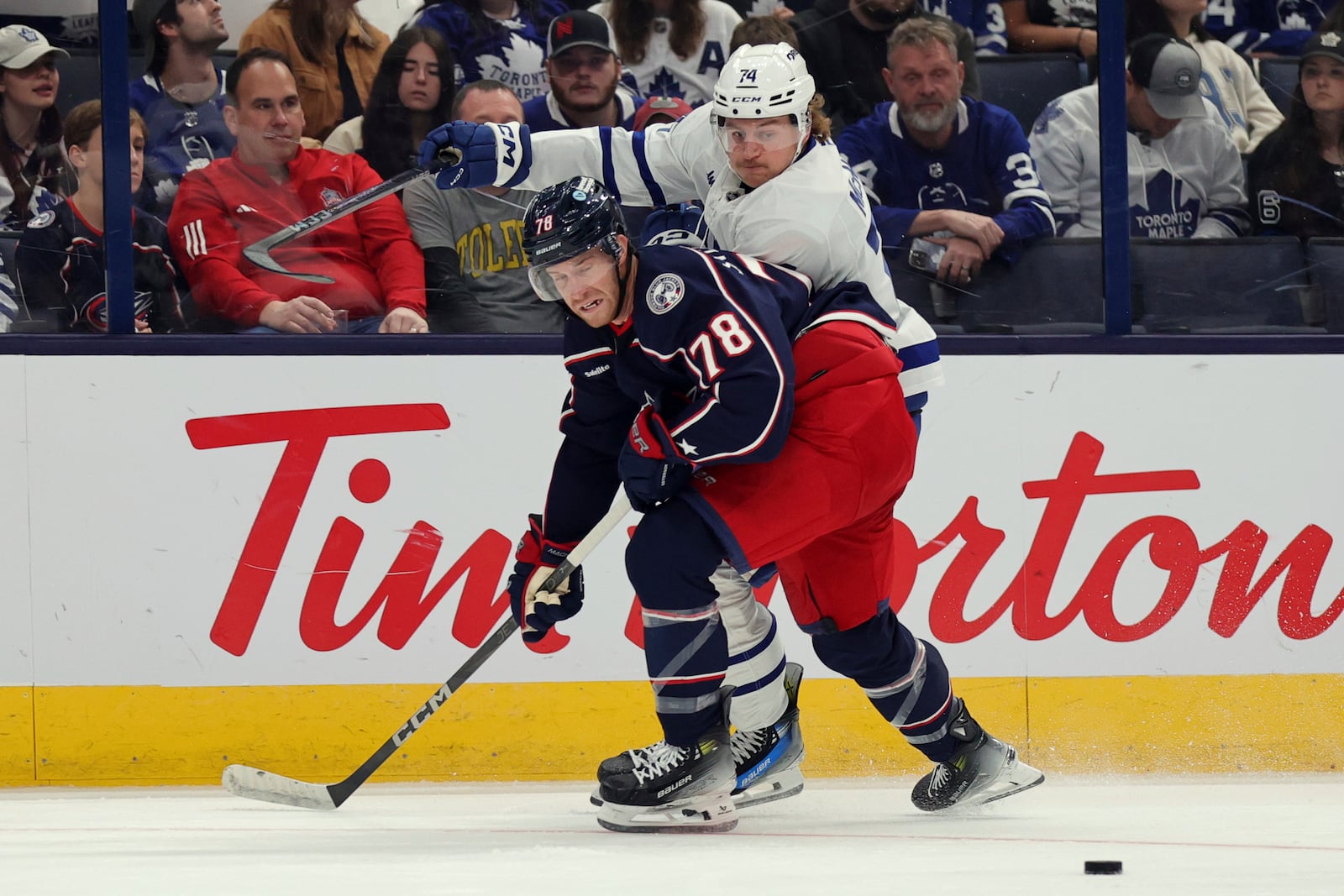 Columbus Blue Jackets defenseman Damon Severson, left, blocks Toronto Maple Leafs forward Bobby McMann from the puck during the first period of an NHL hockey game in Columbus, Ohio, Tuesday, Oct. 22, 2024. (AP Photo/Paul Vernon)