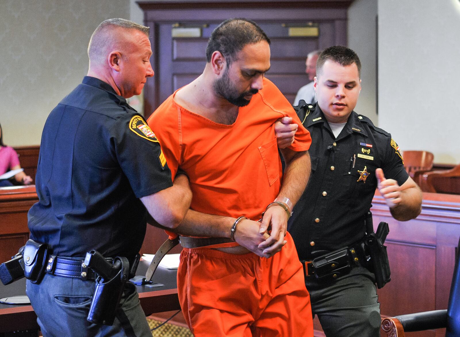 Gurpreet Singh, the West Chester man facing 4 counts of capital murder for the shooting death of 4 family members, was arraigned in Butler County Common Pleas Court Monday, August 5 in Hamilton. Singh fell to the ground while standing at the podium during the arraignment and was help up by Butler County Sheriff's deputies. NICK GRAHAM/STAFF