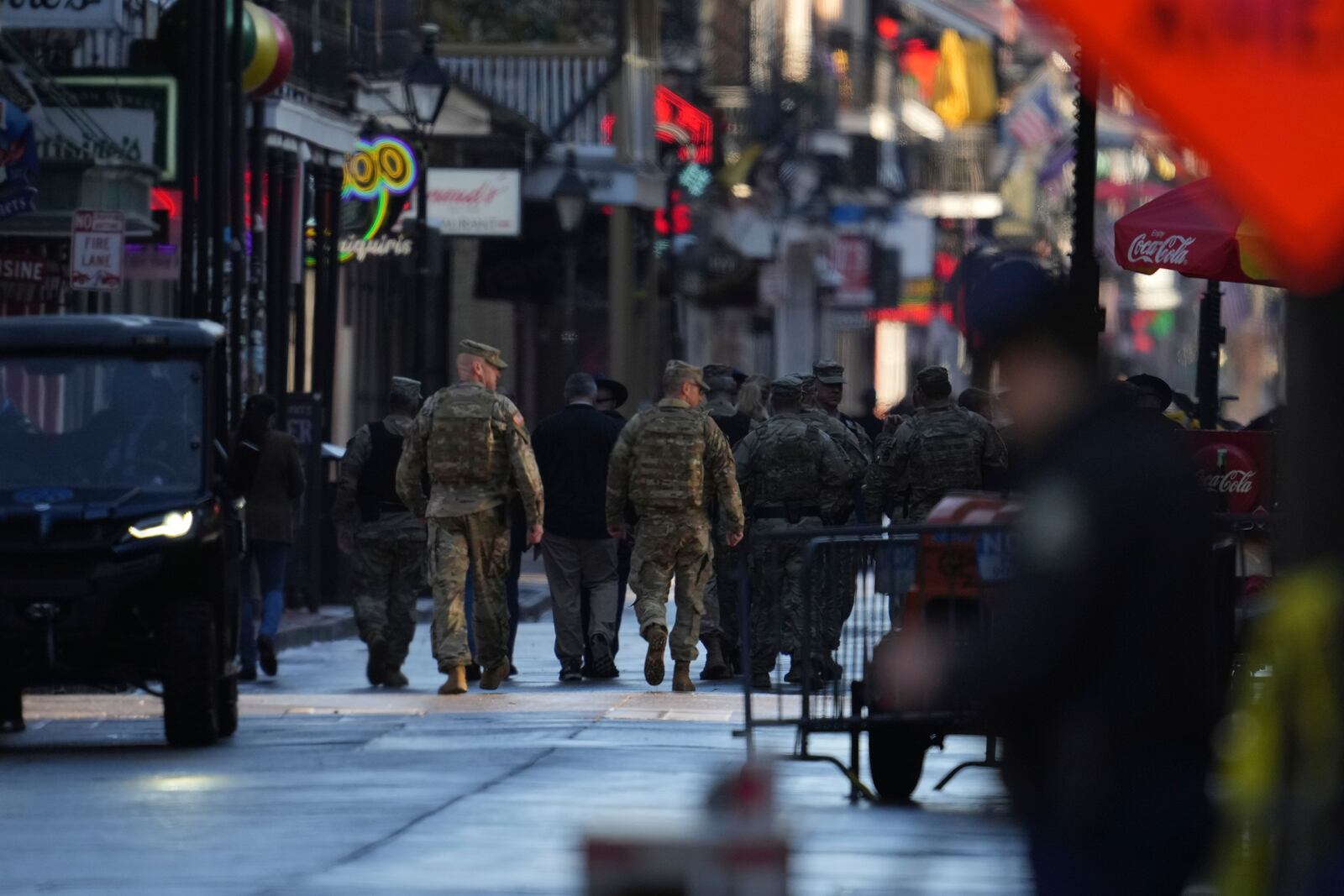 Military personnel walk down Bourbon street, Thursday, Jan. 2, 2025 in New Orleans. (AP Photo/George Walker IV)