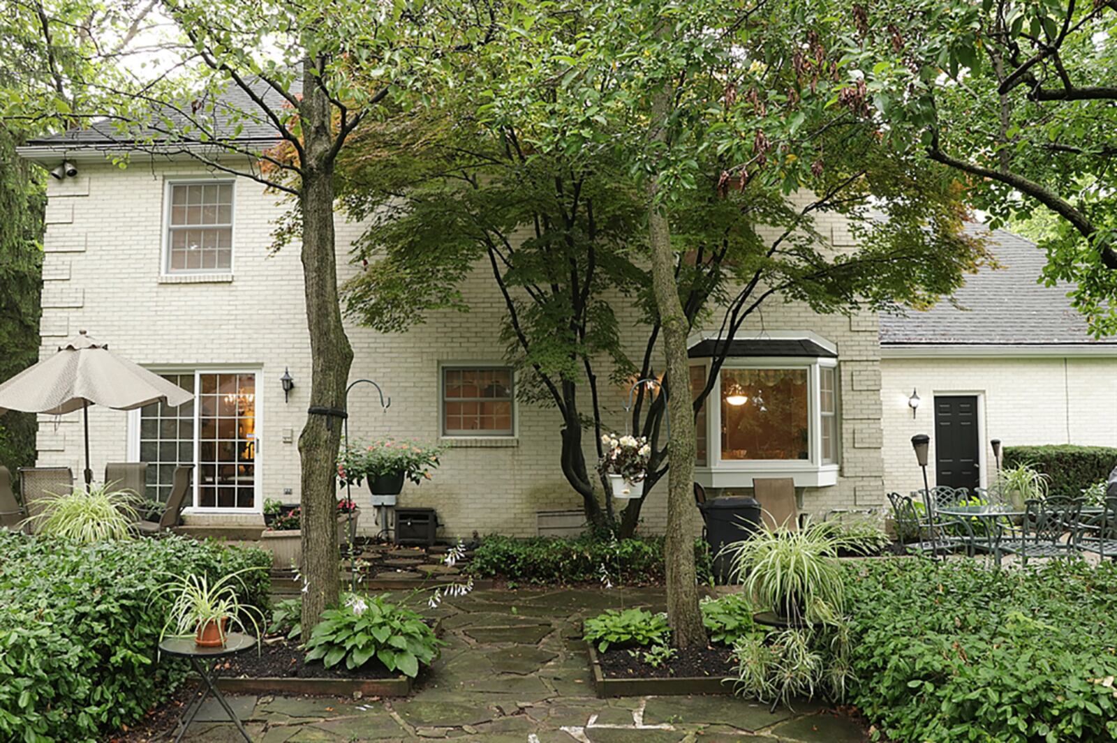 A bay window from the breakfast room looks out over the private back yard. Patio doors from the dining room open to one of two patios with slate-stone pathways that wrap around to the front patio or side driveway. CONTRIBUTED PHOTO BY KATHY TYLER