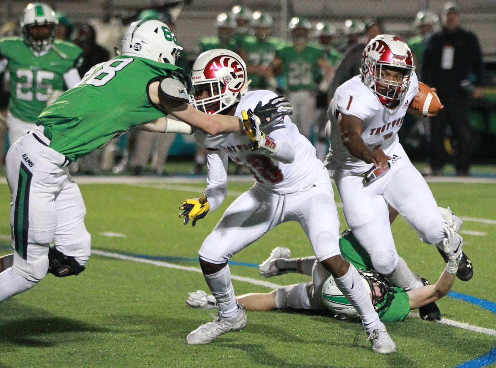 Trotwood QB Keon’tae Huguely (with ball) is taken down from behind as Michael Schweinefuss of Badin (left) closes. Trotwood-Madison defeated Badin 20-7 in a D-III, Region 12 high school football final at Miamisburg on Friday, Nov. 22, 2019. MARC PENDLETON / STAFF