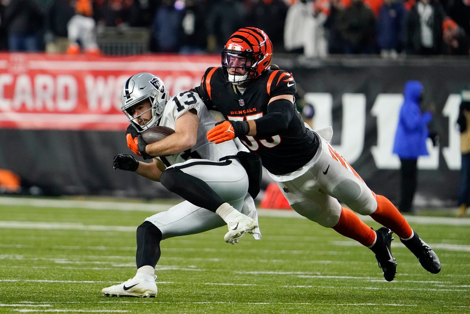 Las Vegas Raiders' Hunter Renfrow (13) is tackled by Cincinnati Bengals' Logan Wilson (55) during the first half of an NFL wild-card playoff football game, Saturday, Jan. 15, 2022, in Cincinnati. (AP Photo/Jeff Dean)