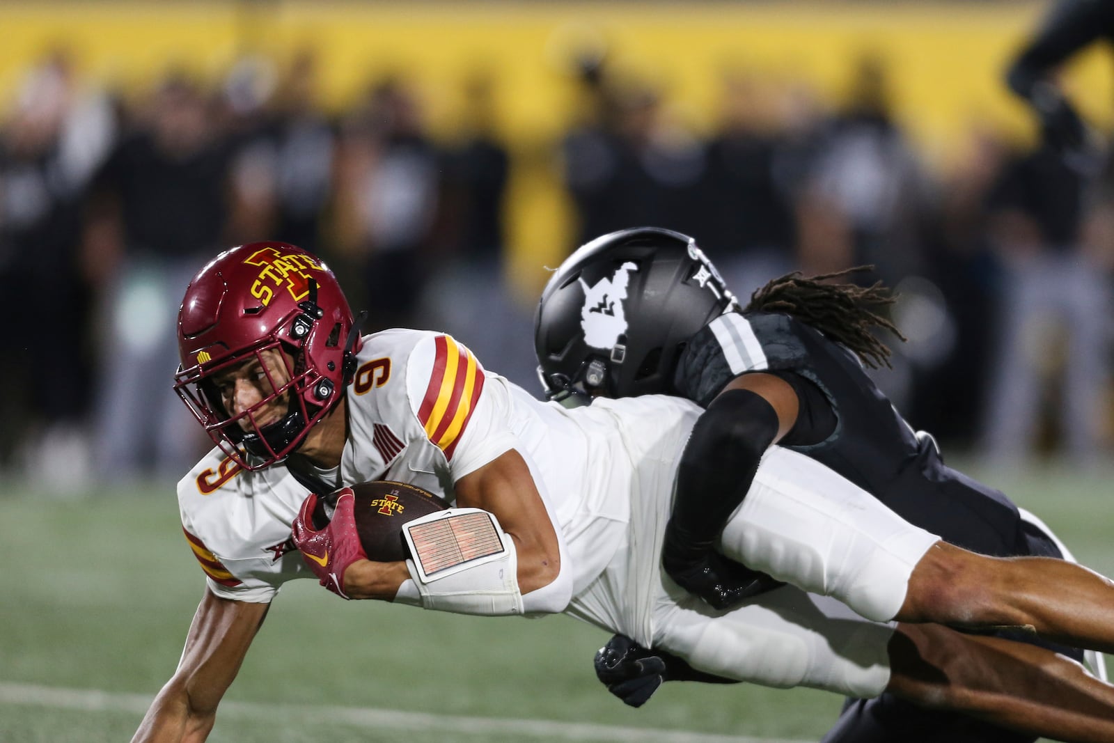 Iowa State wide receiver Jayden Higgins (9) picks up yards after a catch and tackled by West Virginia Garnett Hollis Jr. (1) during the first half of an NCAA college football game, Saturday, Oct. 12, 2024, in Morgantown, W.Va. (AP Photo/William Wotring)