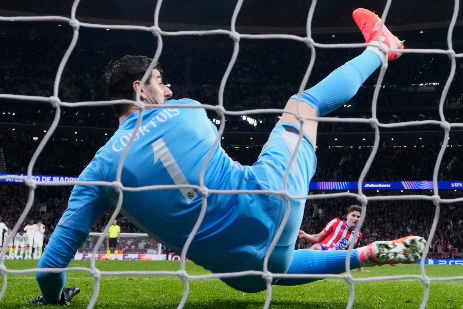 Atletico Madrid's Julian Alvarez, right, stands up after falling to the ground when taking a penalty kick during a shootout at the end of the Champions League round of 16, second leg, soccer match between Atletico Madrid and Real Madrid at the Metropolitano stadium in Madrid, Spain, Wednesday, March 12, 2025. (AP Photo/Manu Fernandez)