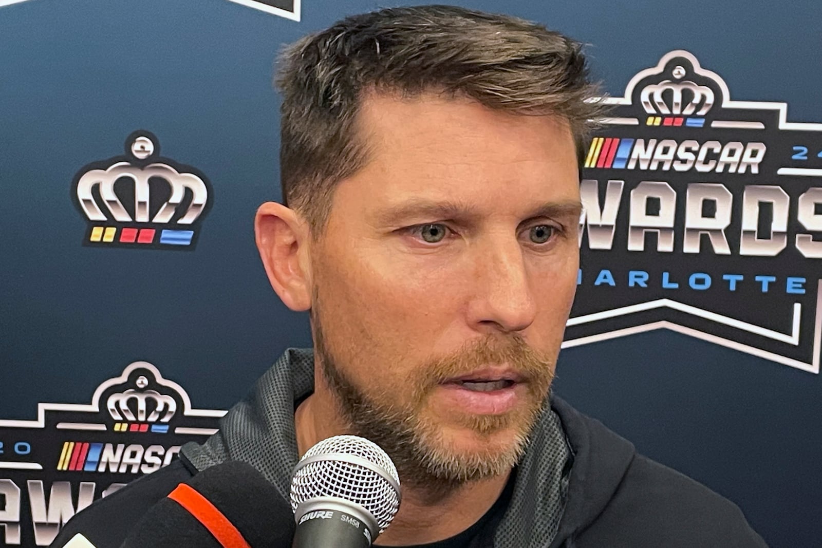 NASCAR auto racing driver Denny Hamlin speaks ahead of the NASCAR awards ceremony in Charlotte N.C., Friday, Nov. 22, 2024. (AP Photo/Steve Reed)