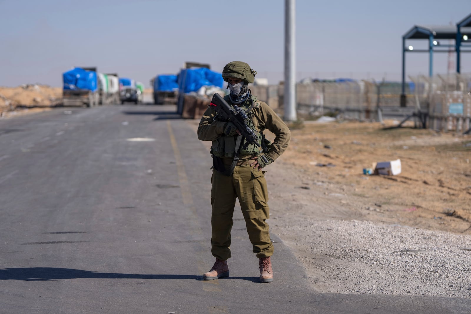 An Israeli soldier stands guard on the Palestinian side of the Kerem Shalom crossing between southern Israel and Gaza, Thursday, Dec. 19, 2024. (AP Photo/Ohad Zwigenberg)