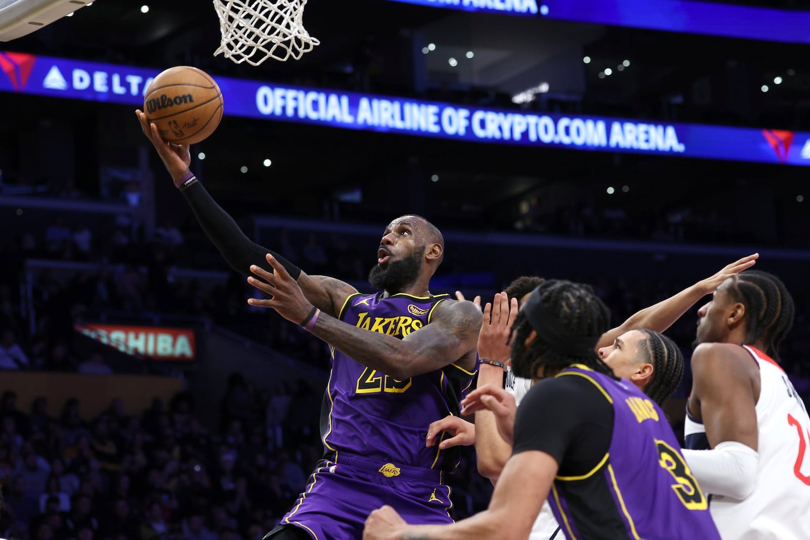 Los Angeles Lakers forward LeBron James makes a layup against the Washington Wizards during the first half on an NBA basketball game, Tuesday, Jan. 21, 2025, in Los Angeles. (AP Photo/Raul Romero Jr.)