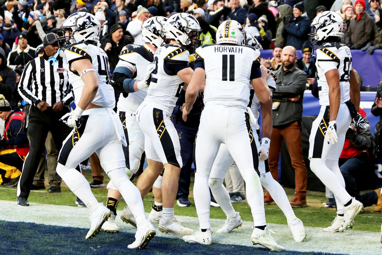 Navy players celebrate after a touchdown during the first half of an NCAA college football game against Army, Saturday, Dec. 14, 2024, in Landover, Md. (AP Photo/Daniel Kucin Jr.)