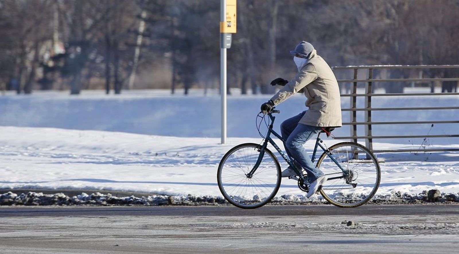 A bicyclist crosses the Stewart Street Bridge in bitterly cold temperatures. TY GREENLEES / STAFF