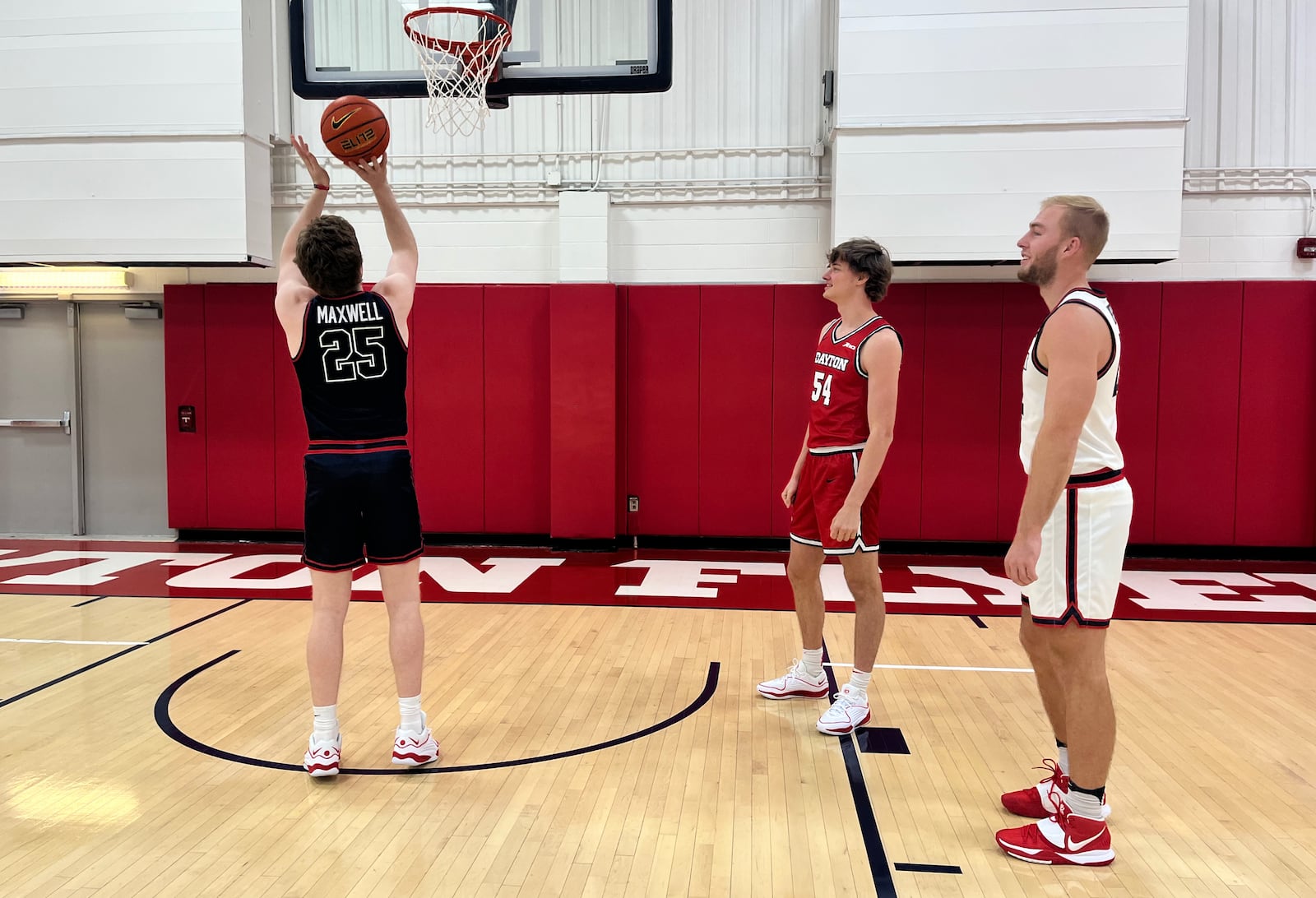 Dayton walk-ons Will Maxwell, Atticus Schuler and C.J. Napier model the team's new uniforms during a media session at the Cronin Center on Tuesday, Oct. 24, 2023. David Jablonski/Staff