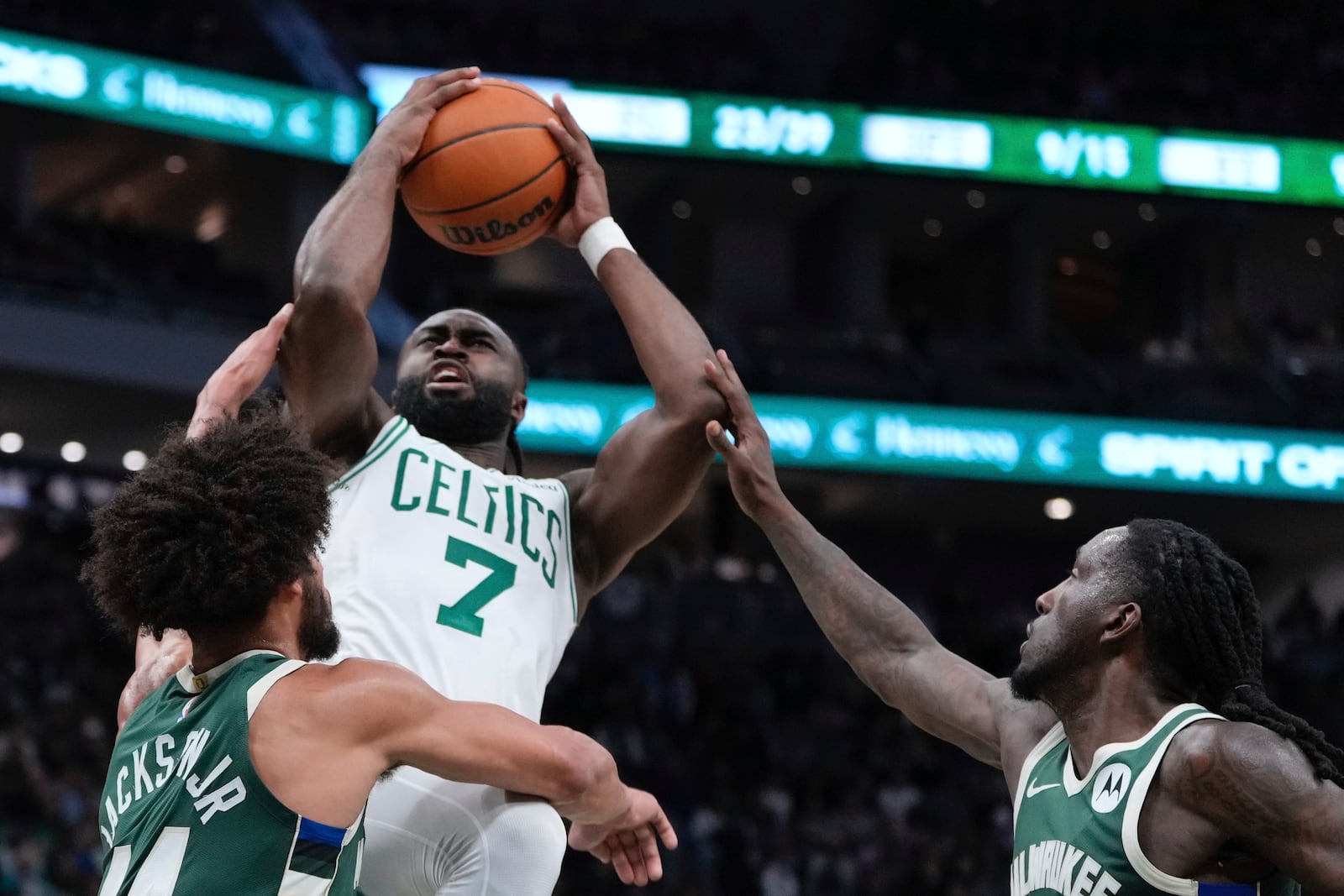 Boston Celtics' Jaylen Brown is fouled shooting between Milwaukee Bucks' Chris Livingston and Andre Jackson Jr. during the first half of an NBA basketball game Sunday, Nov. 10, 2024, in Milwaukee. (AP Photo/Morry Gash)