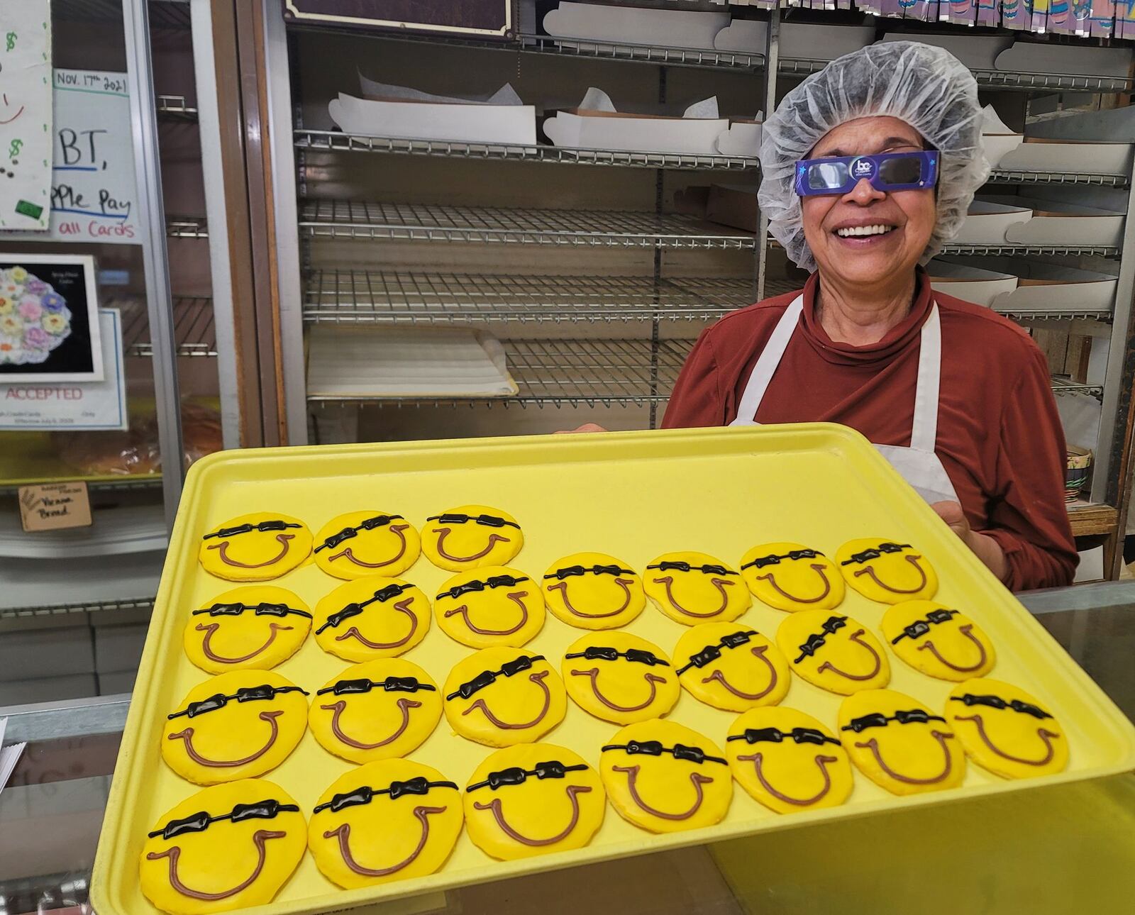 Vera Slampka, owner of Central Pastry in Middletown, shows off a tray of cookies made for the total solar eclipse. NICK GRAHAM/STAFF