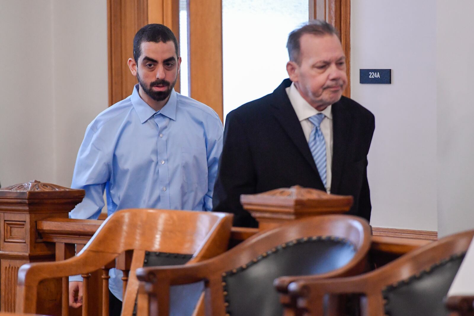 Hadi Matar, left, charged with severely injuring author Salman Rushdie in a 2022 knife attack, is led into Chautauqua County court by public defender Nathaniel Barone before the start of jury selection in Mayville, N.Y., Tuesday, Feb. 4, 2025. (AP Photo/Adrian Kraus)