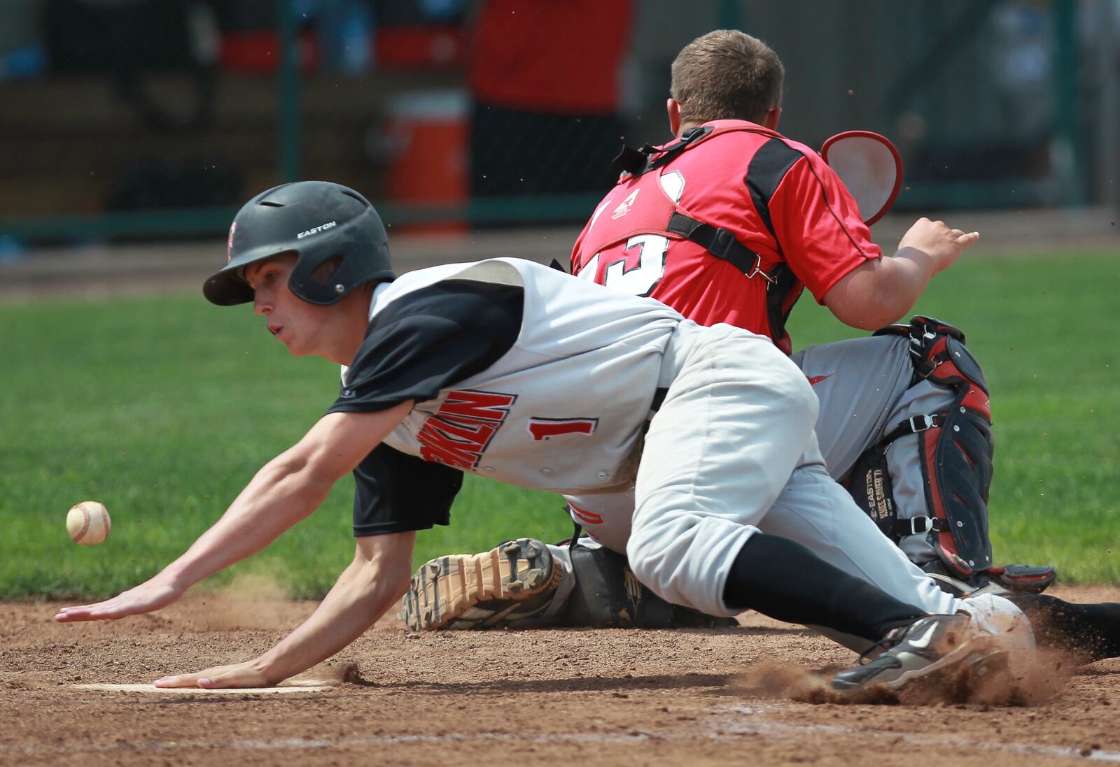 Franklin's Travis Lakins (1) makes it past Tippecanoe catcher B.J. Donathan for what would have been a game-tying fifth-inning run. Lakins was later ruled to have left the base early on a sacrifice fly. Tippecanoe held on to win 3-2 in a Division II regional baseball semifinal on Thursday, May 30 at the University of Dayton. CHRIS STEWART / STAFF