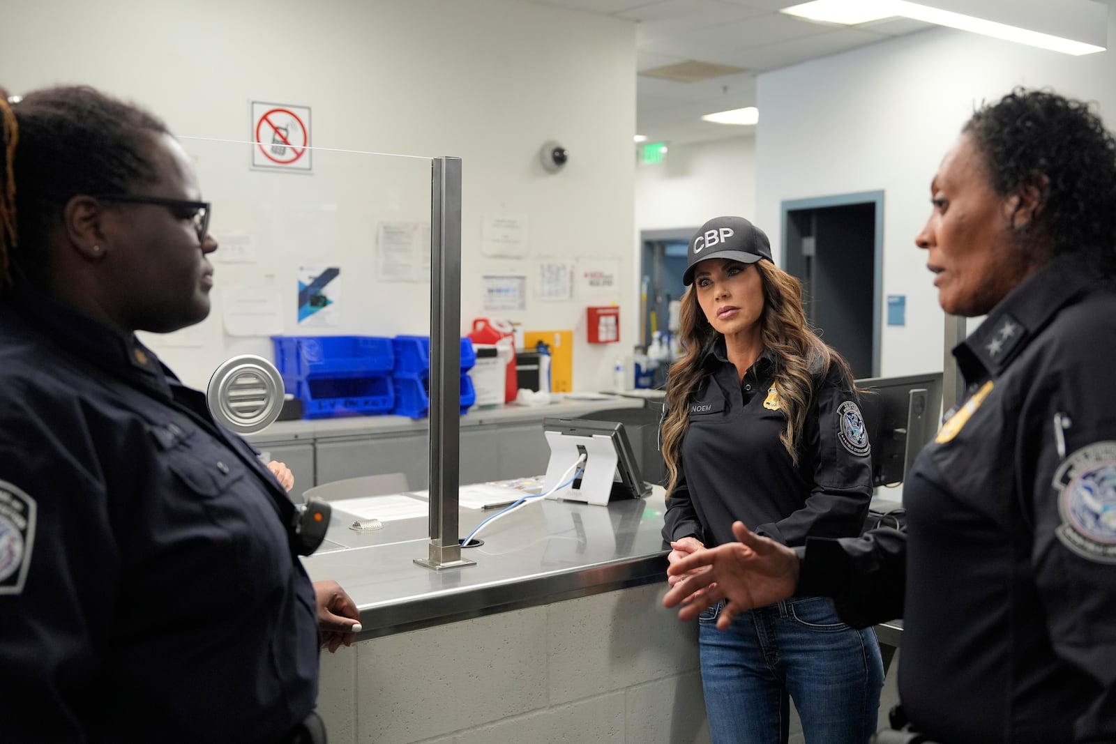 Homeland Security Secretary Kristi Noem, center, tours the San Ysidro Port of Entry, Sunday, March 16, 2025, in San Diego. (AP Photo/Alex Brandon)