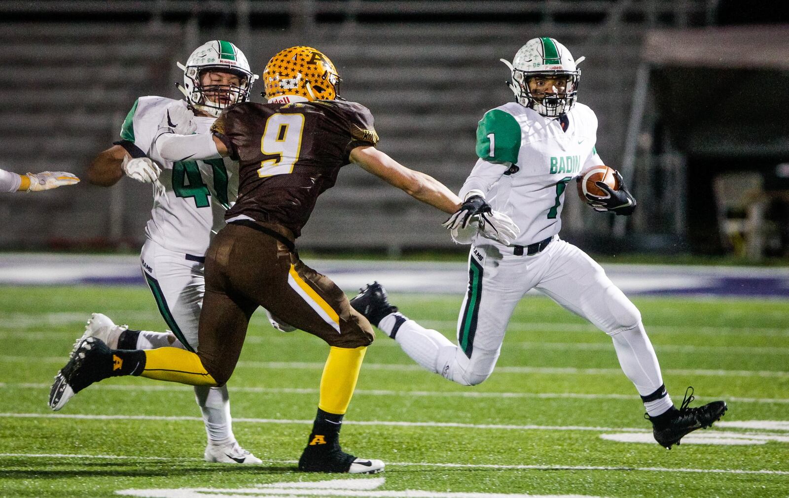 Badin’s Davon Starks (1) gets some blocking help from teammate Ethan Wishart (41) as Alter’s Derek Willits tries to make a defensive play during Friday night’s Division III, Region 12 playoff semifinal at Barnitz Stadium in Middletown. NICK GRAHAM/STAFF