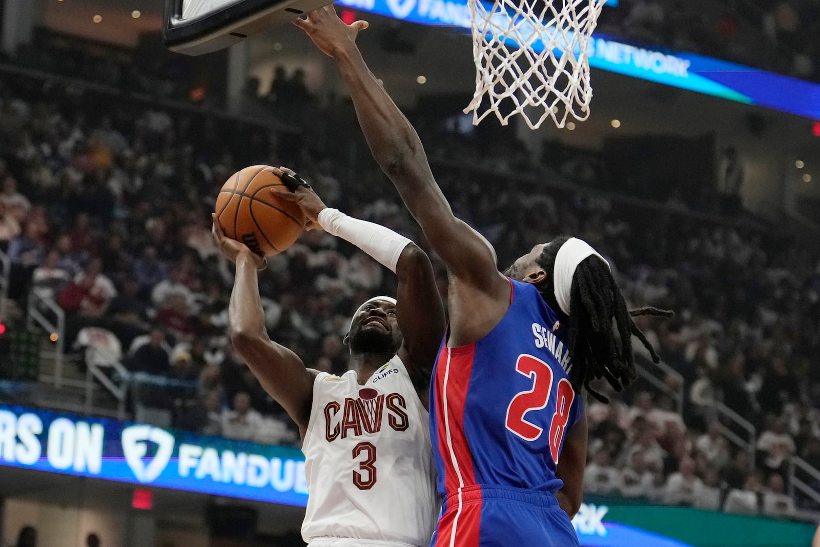 Cleveland Cavaliers guard Caris LeVert (3) shoots as Detroit Pistons center Isaiah Stewart (28) defends in the first half of an NBA basketball game, Friday, Oct. 25, 2024, in Cleveland. (AP Photo/Sue Ogrocki)