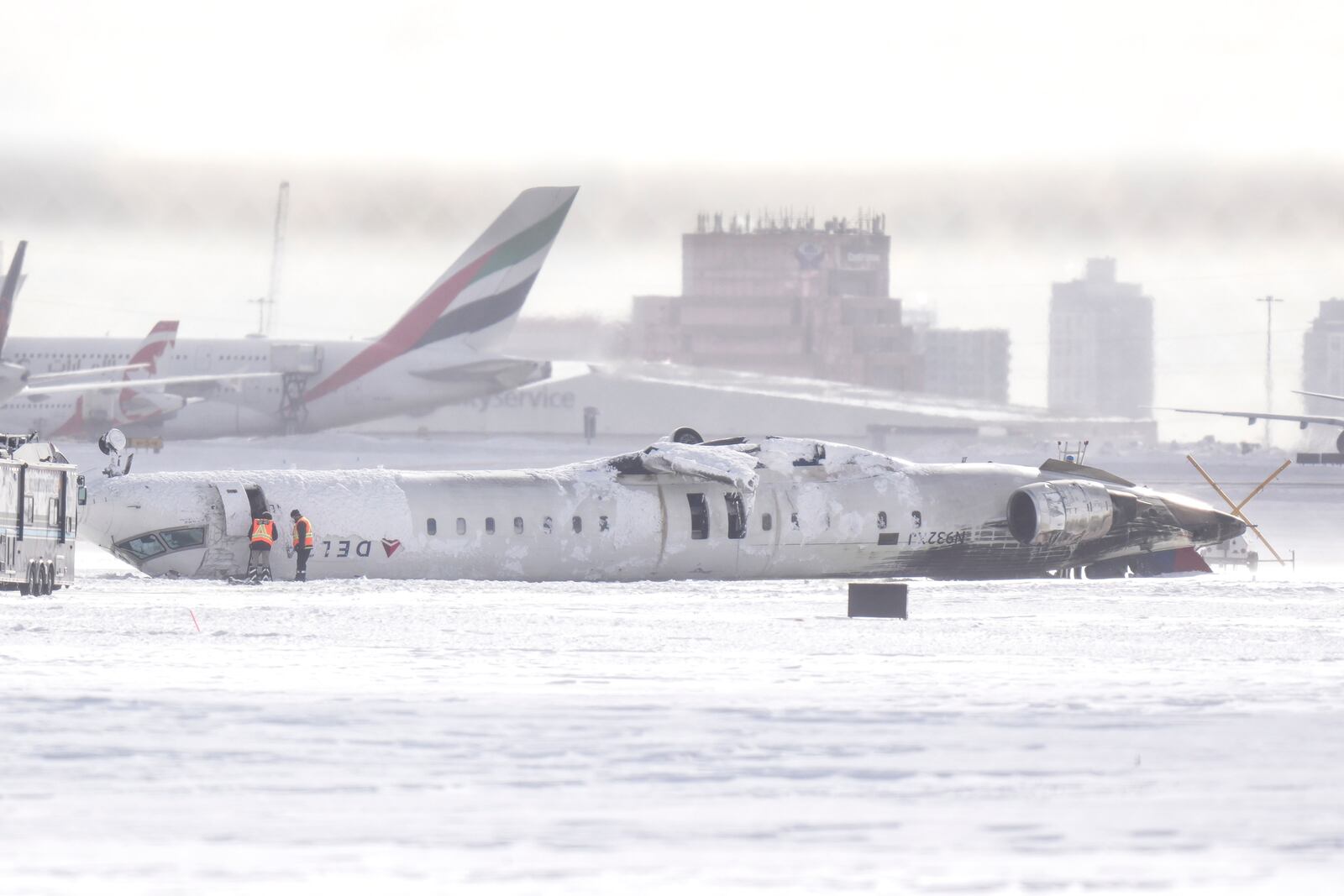 A Delta Air Lines plane lies upside down at Toronto Pearson Airport on Tuesday, Feb. 18, 2025. (Chris Young/The Canadian Press via AP)