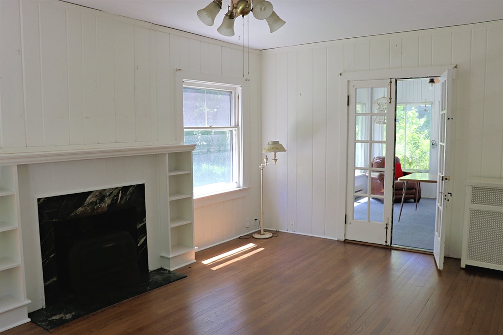 French doors open off the family room into a screen-enclosed porch with views of the backyard gardens.