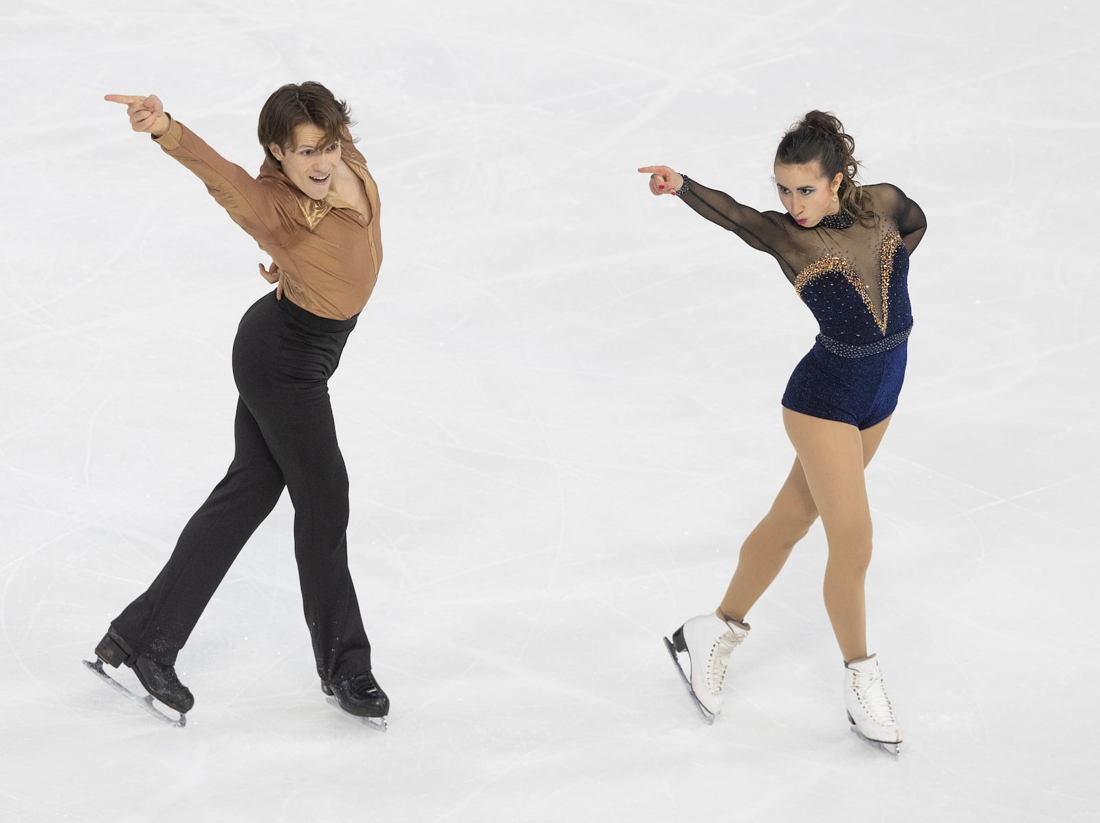 Katarina Wolfkostin, right, and Dimitry Tsarevski, left, perform during the ice dance rhythm dance competition at the U.S. figure skating championships Friday, Jan. 24, 2025, in Wichita, Kan. (AP Photo/Travis Heying)