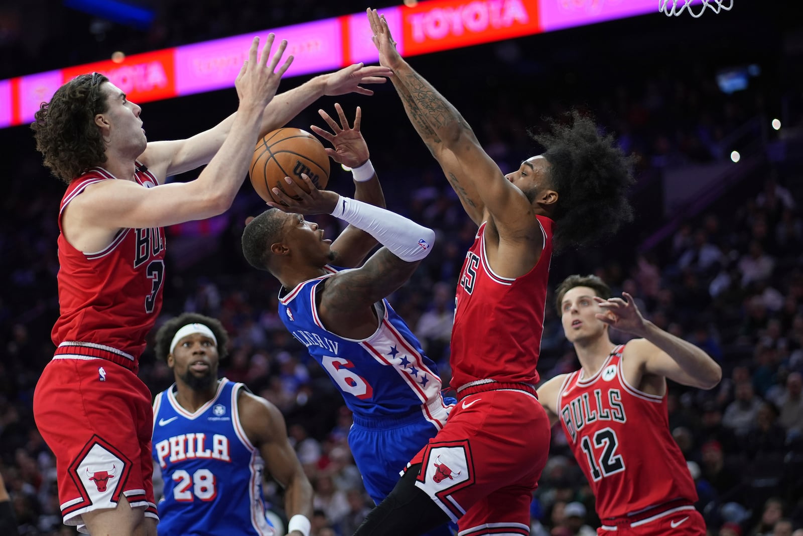 Philadelphia 76ers' Lonnie Walker IV, center, cannot get a shot past Chicago Bulls' Josh Giddey, left, and Coby White during the first half of an NBA basketball game Monday, Feb. 24, 2025, in Philadelphia. (AP Photo/Matt Slocum)