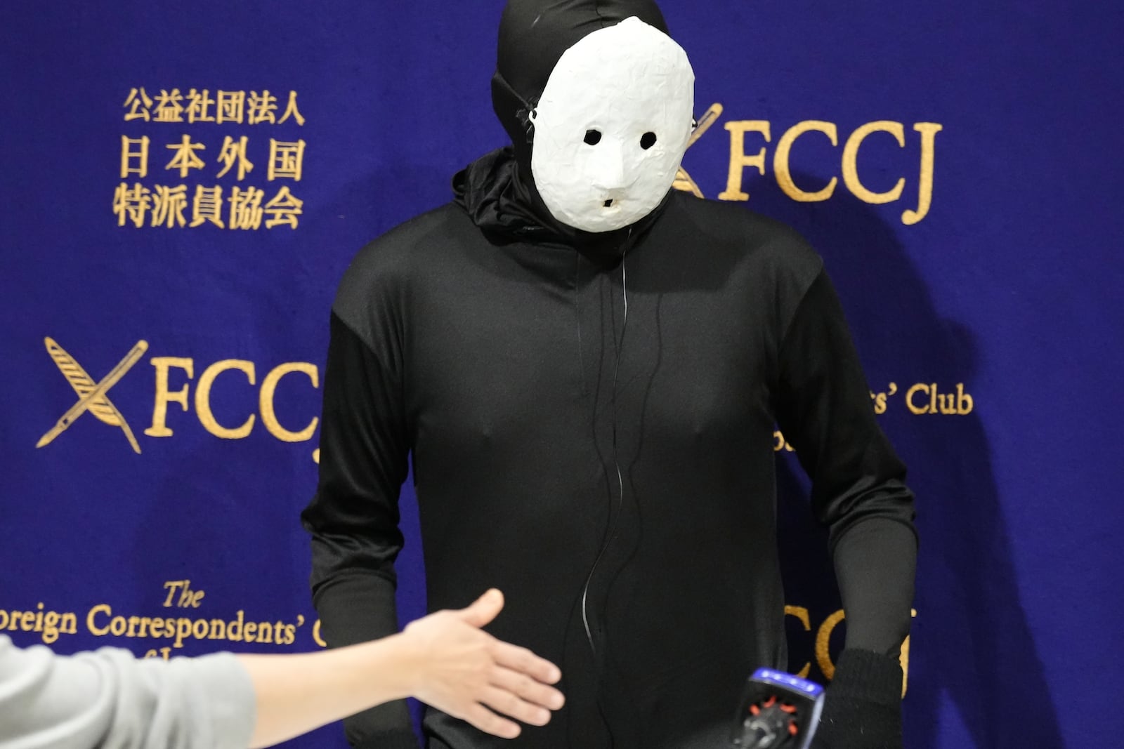 Uketsu, a Japanese YouTuber and horror author arrives at the venue of his media conference at the Foreign Correspondents' Club of Japan, Thursday, Jan. 16, 2025, in Tokyo. (AP Photo/Eugene Hoshiko)