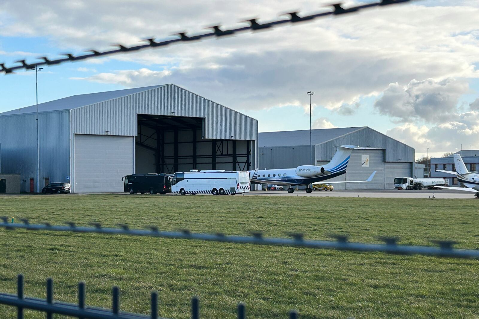 A plane believed to be carrying former Philippine President Rodrigo Duterte is parked next to a bus at Rotterdam The Hague Airport in the Netherlands, Wednesday, March 12, 2025. (AP Photo/Mark Carlson)