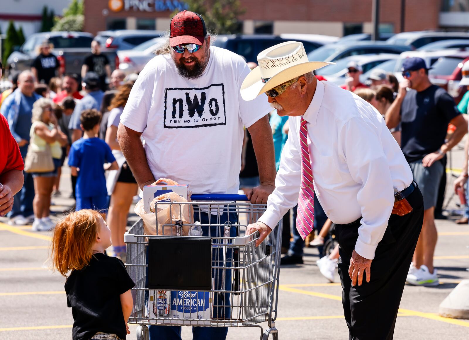 Butler County Sheriff Richard K. Jones greets hundreds of Hulkamaniacs lined up to meet Hulk Hogan in town promoting his Real American Beer Thursday, Aug. 22, 2024 at Kroger on Yankee Road in Liberty Township. NICK GRAHAM/STAFF