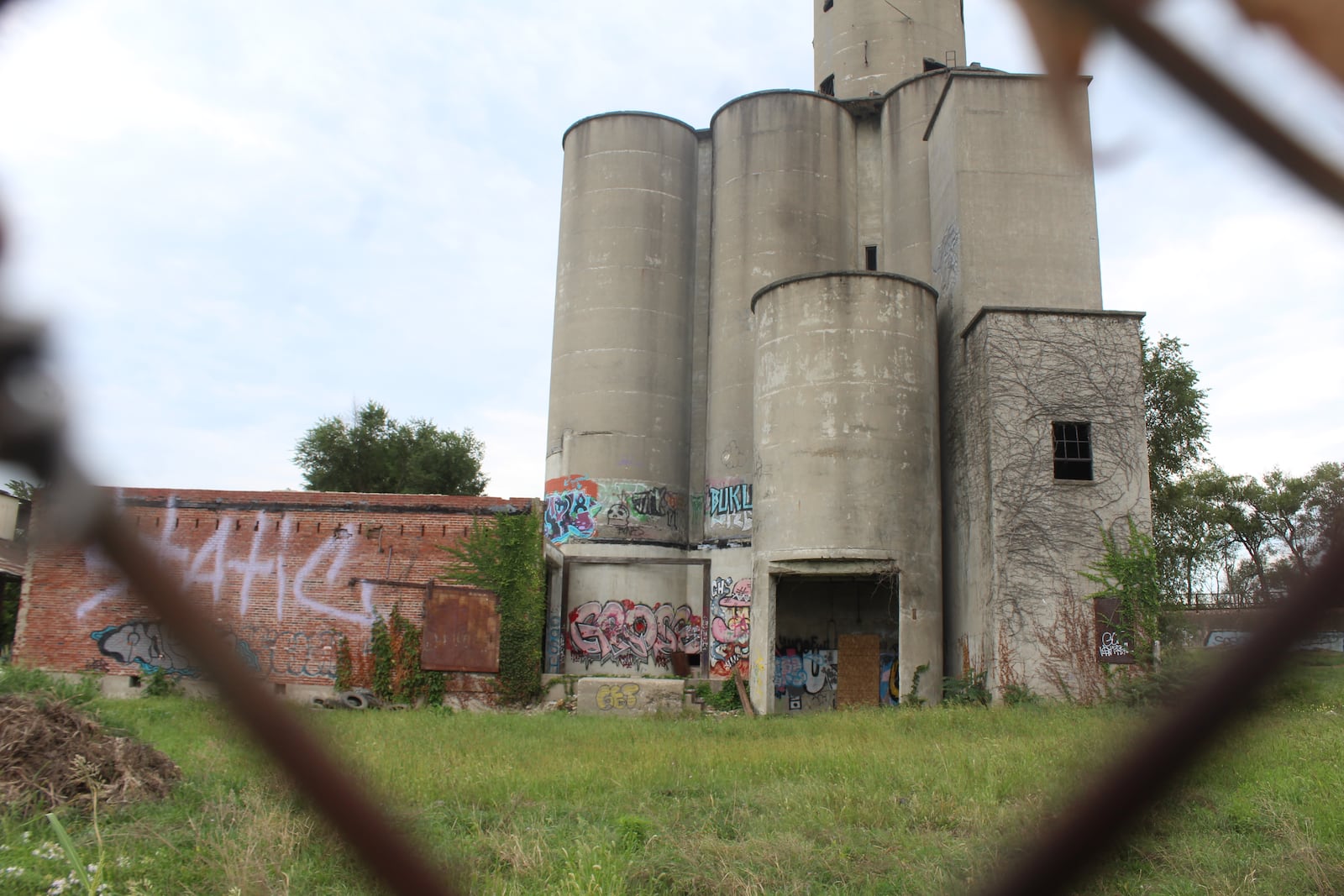 Graffiti on the side of an abandoned commercial property near the 2nd Street Market in Dayton. CORNELIUS FROLIK / STAFF