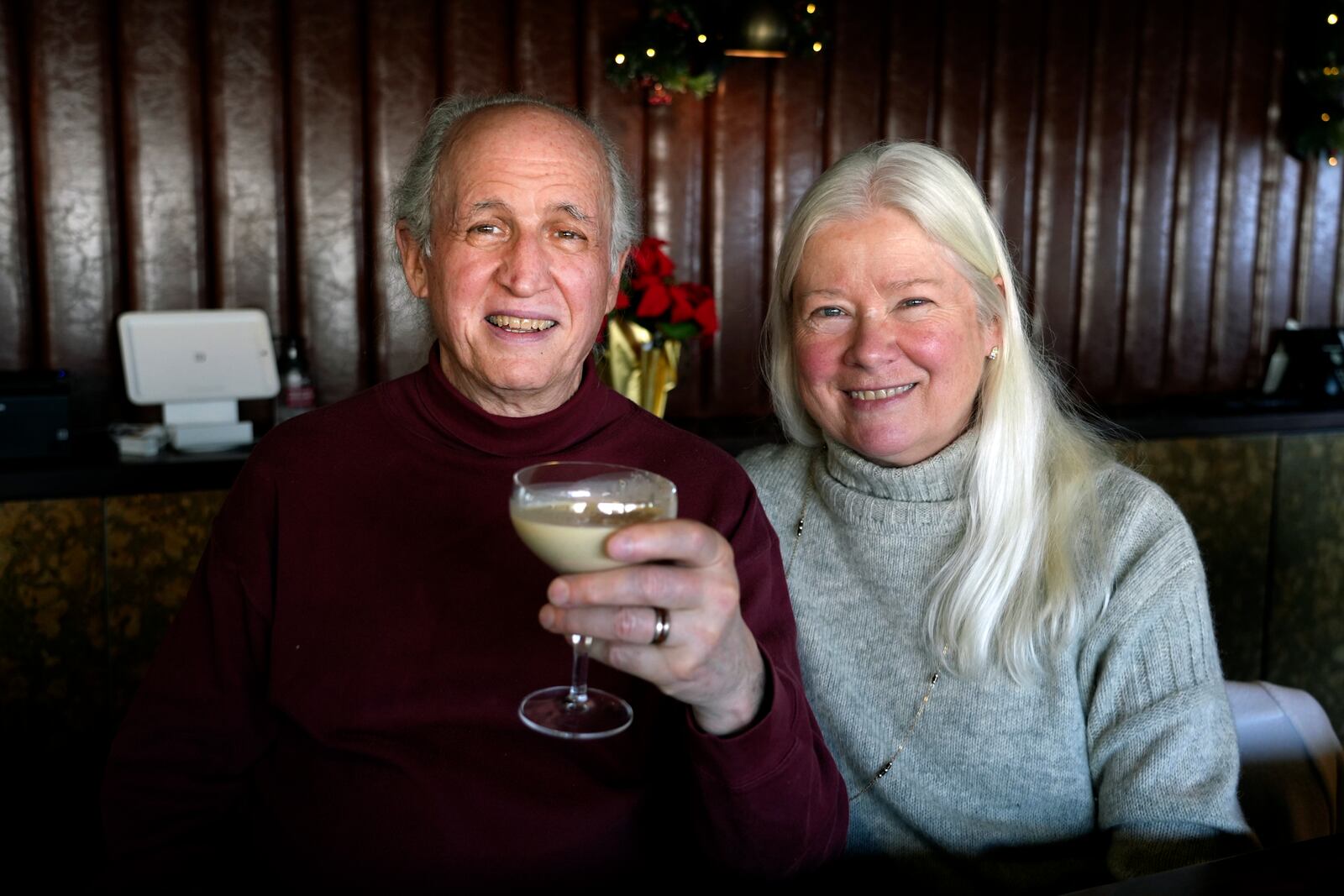 Phil and Laurie Kenny drink eggnog at Scoma's Restaurant in San Francisco on Dec. 10, 2024. The eggnog is prepared 11 months in advance. (AP Photo/Terry Chea)