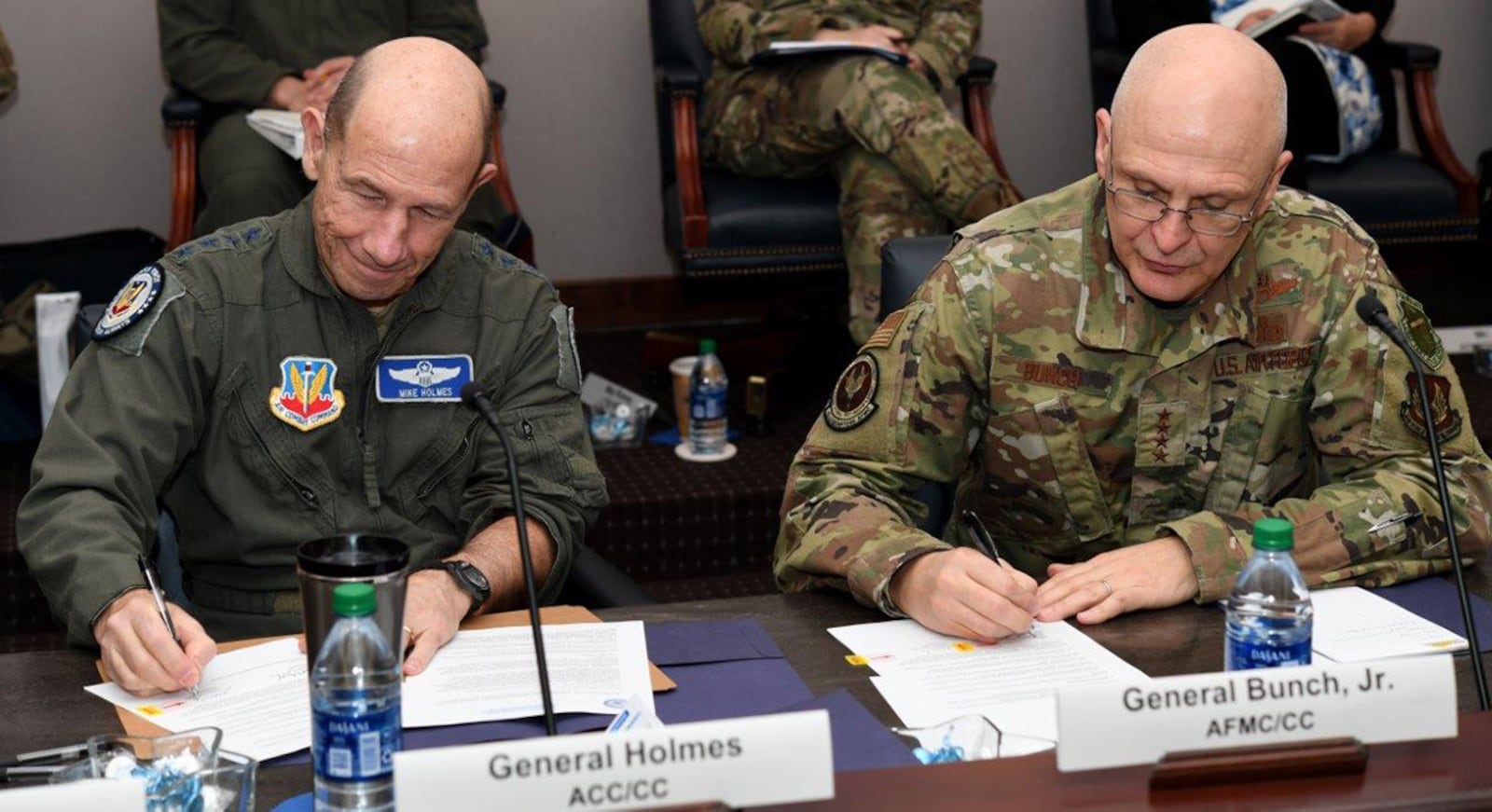 Gen. Mike Holmes (left), commander of Air Combat Command, and Gen. Arnold W. Bunch Jr., commander of Air Force Material Command, both sign a memorandum between the two major commands during the Technology and Acquisition Sustainment Review conference Jan. 29 at Joint Base Langley-Eustis, Va. The commanders are taking an active approach to ensuring a collaboration channel exists between acquisition program offices and operational wings. U.S. AIR FORCE PHOTO/MASTER SGT. DARYL KNEE