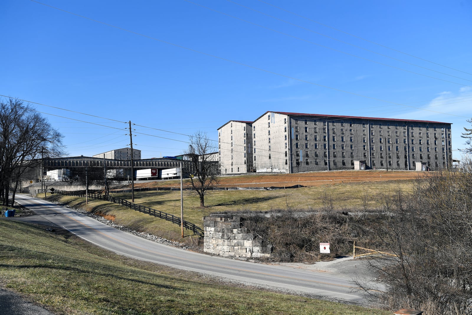 Bourbon barrel rack houses sit on a hillside at the Wild Turkey Distillery in Lawrenceburg, Ky., Monday, Feb. 3, 2025. (AP Photo/Timothy D. Easley)