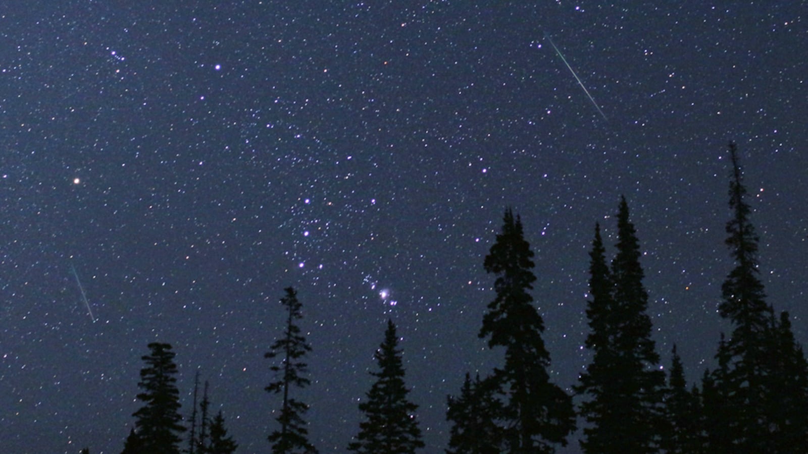 The constellation Orion is framed by two Perseid meteors on Aug. 12, 2018 in Cedar Breaks National Monument, Utah.