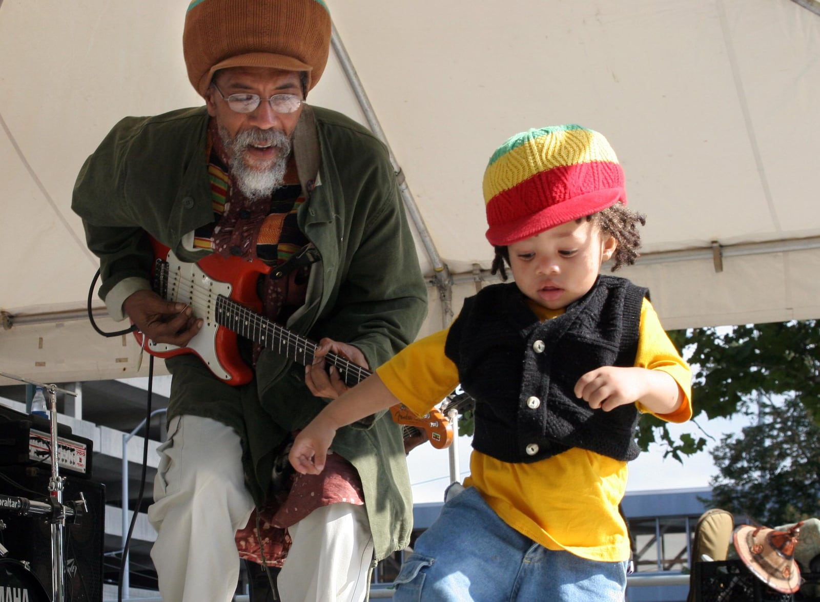 9/3/06 -- ddn090406reggaep -- Mandela Blunt, 18 months, joins Lesterfari of the Columbus band Vision on stage at the Third World Reggae Festival held at Dave Hall Plaza.  Six bands worked from alternating stages to keep the music flowing throughout the day. PHOTO BY JAN UNDERWOOD