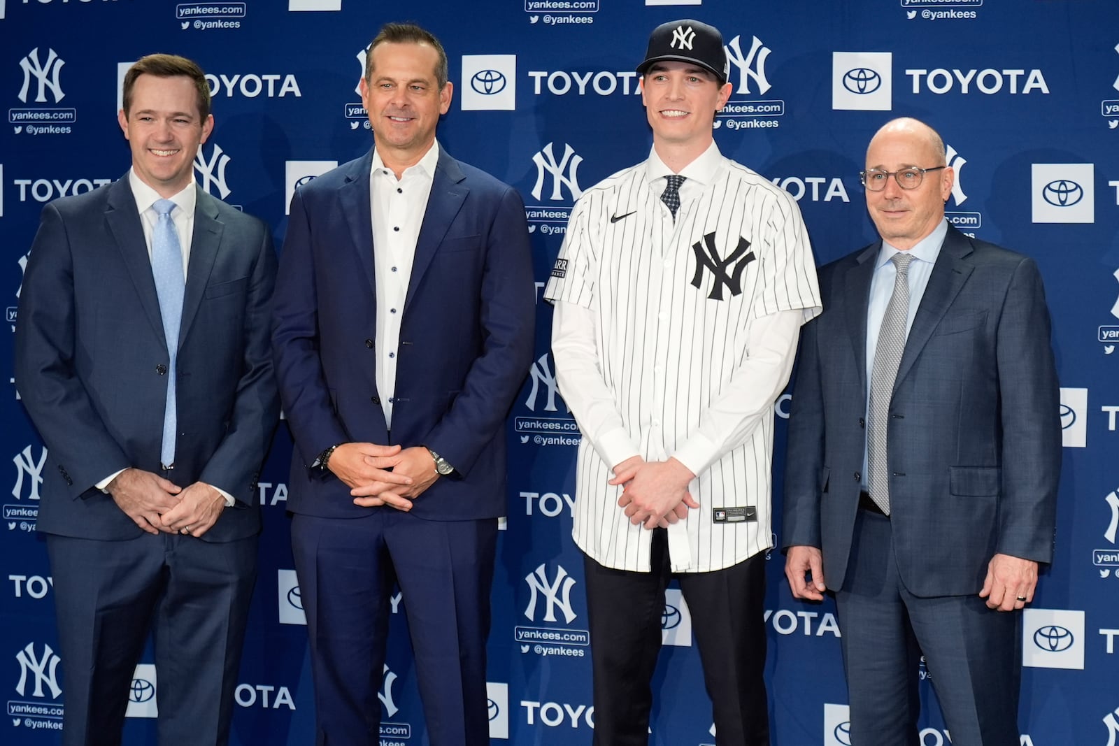 New York Yankees' Max Fried, second from right, poses with general manager Brian Cashman, right, manager Aaron Boone, second from left, and pitching coach Matt Blake, left, during a baseball news conference, Wednesday, Dec. 18, 2024, in New York. (AP Photo/Frank Franklin II)