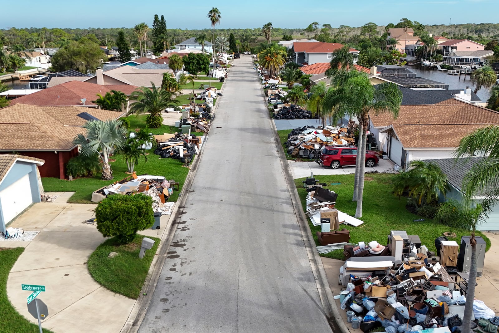 Debris from homes flooded in Hurricane Helene sits curbside as Hurricane Milton approaches on Tuesday, Oct. 8, 2024, in Port Richey, Fla. (AP Photo/Mike Carlson)