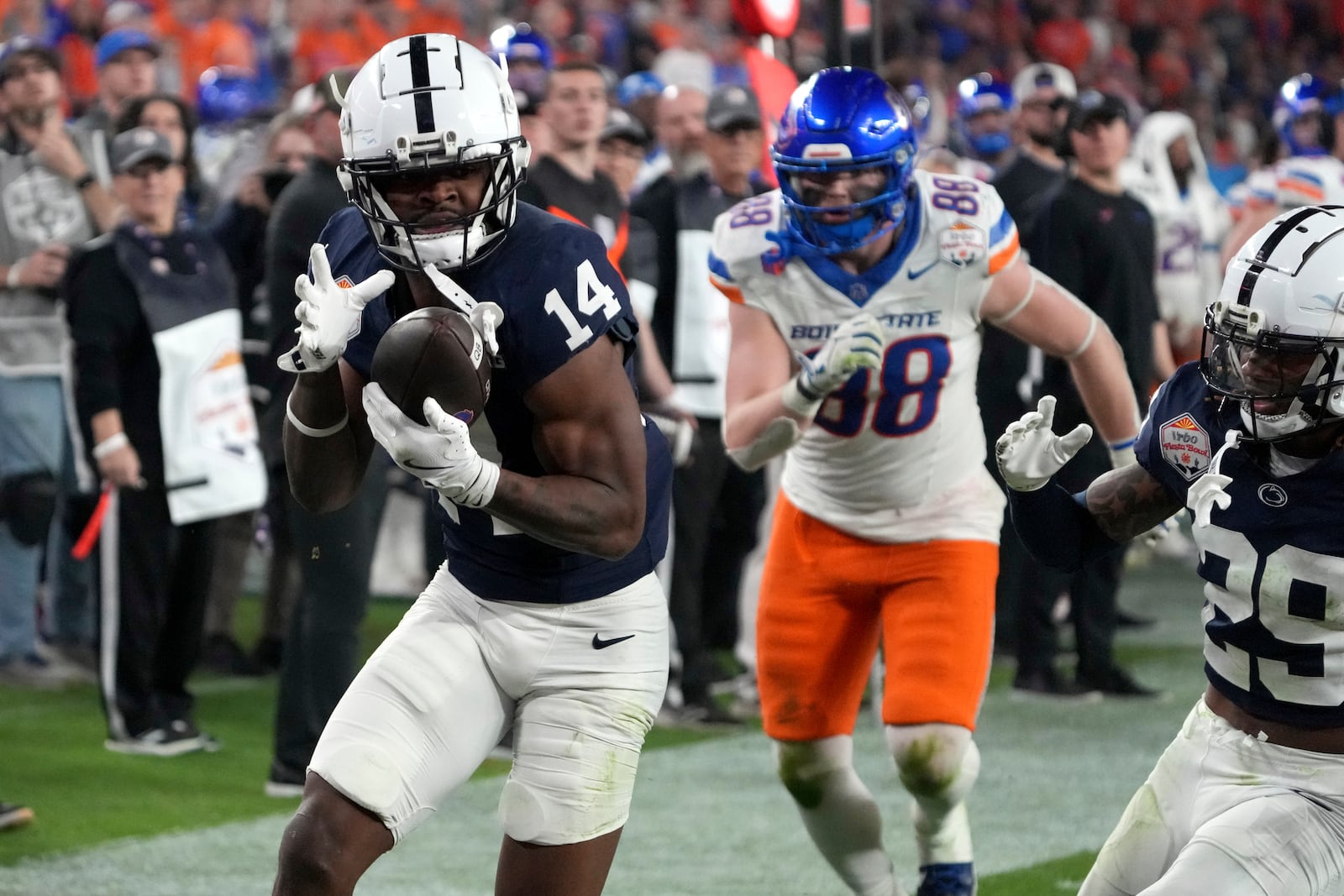 Penn State safety Tyrece Mills (14) intercepts a pass against Boise State during the second half of the Fiesta Bowl College Football Playoff game, Tuesday, Dec. 31, 2024, in Glendale, Ariz. (AP Photo/Rick Scuteri)