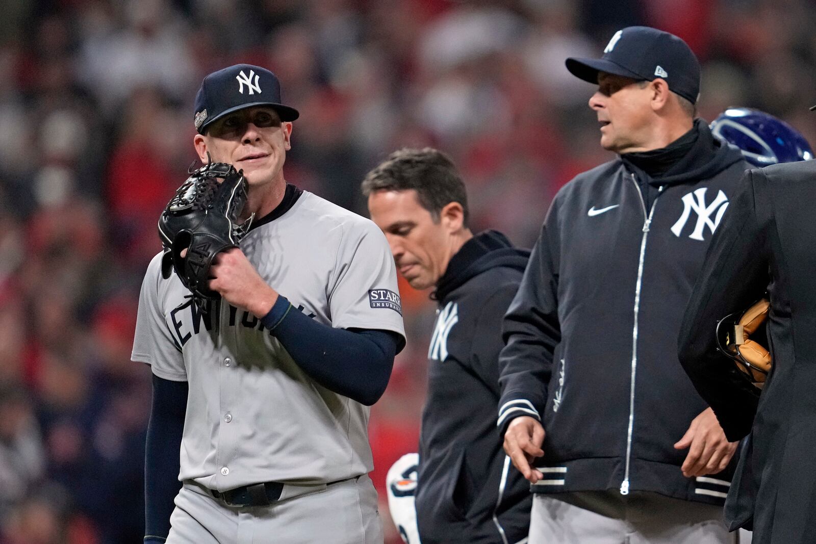 New York Yankees relief pitcher Ian Hamilton, left, leaves the game during the sixth inning in Game 3 of the baseball AL Championship Series against the Cleveland GuardiansvThursday, Oct. 17, 2024, in Cleveland.(AP Photo/Godofredo Vásquez )