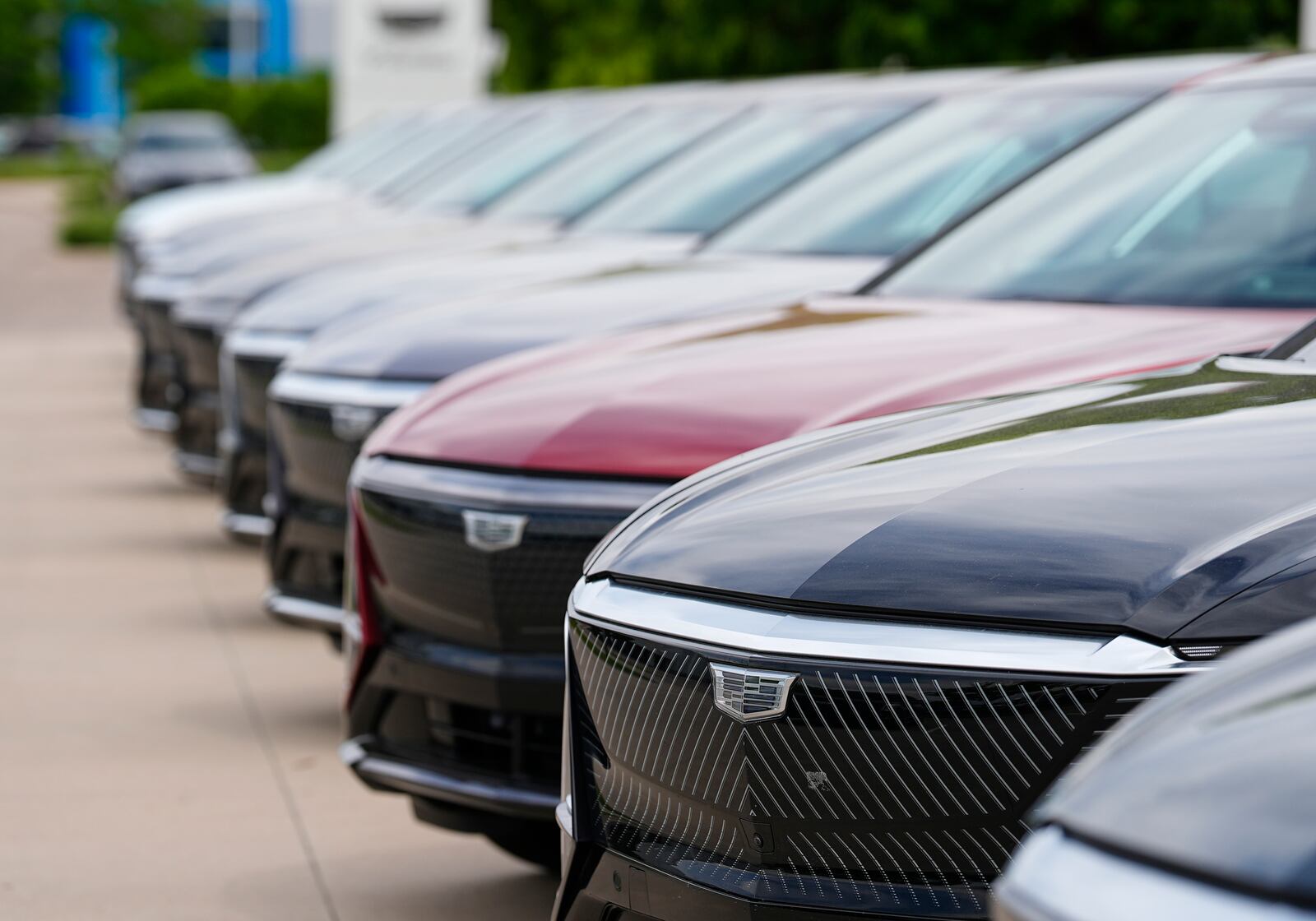 FILE - Unsold 2024 electric Lyriq utility vehicles sit in a row outside a Cadillac dealership on June 2, 2024, in Lone Tree, Colo. (AP Photo/David Zalubowski, File)