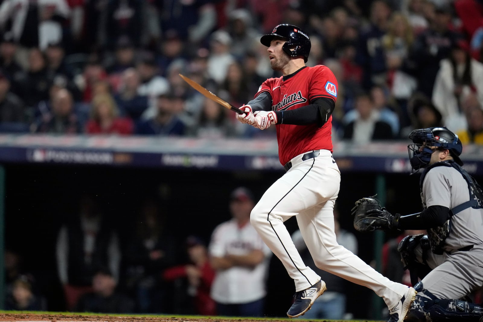 Cleveland Guardians' David Fry watches his hit against the New York Yankees during the fifth inning in Game 5 of the baseball AL Championship Series Saturday, Oct. 19, 2024, in Cleveland. (AP Photo/Sue Ogrocki)