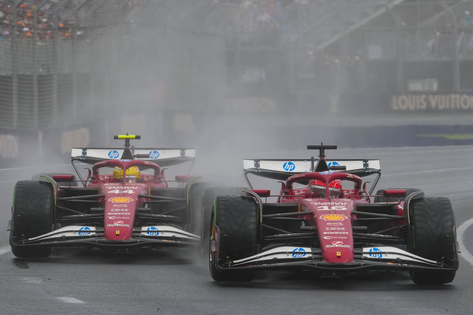 Ferrari driver Charles Leclerc, right, of Monaco and teammate Lewis Hamilton of Britain compete during the Australian Formula One Grand Prix at Albert Park, in Melbourne, Australia, Sunday, March 16, 2025. (AP Photo/Scott Barbour)