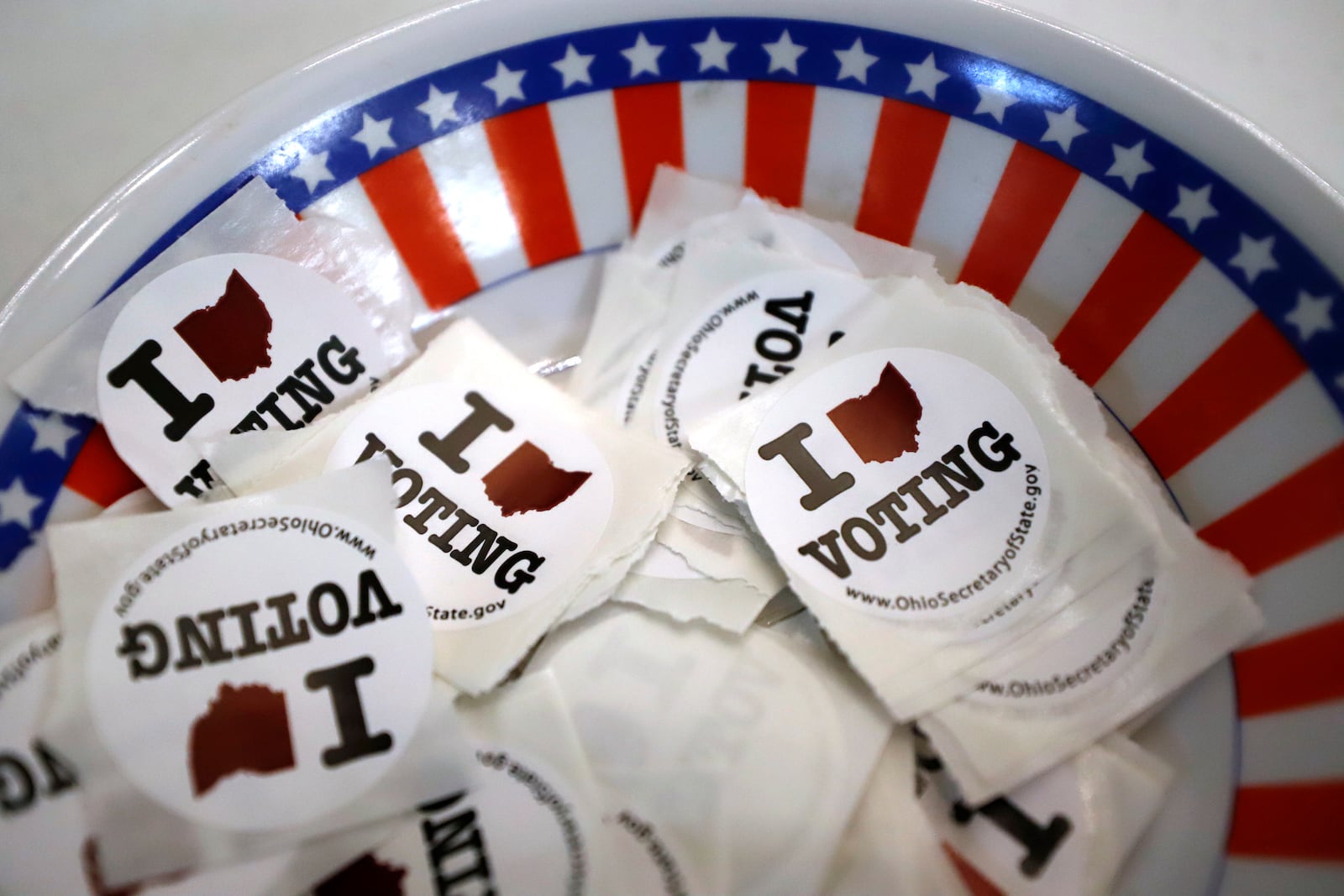 A bowl of voting stickers for early voters. (AP Photo/Gene J. Puskar, File)