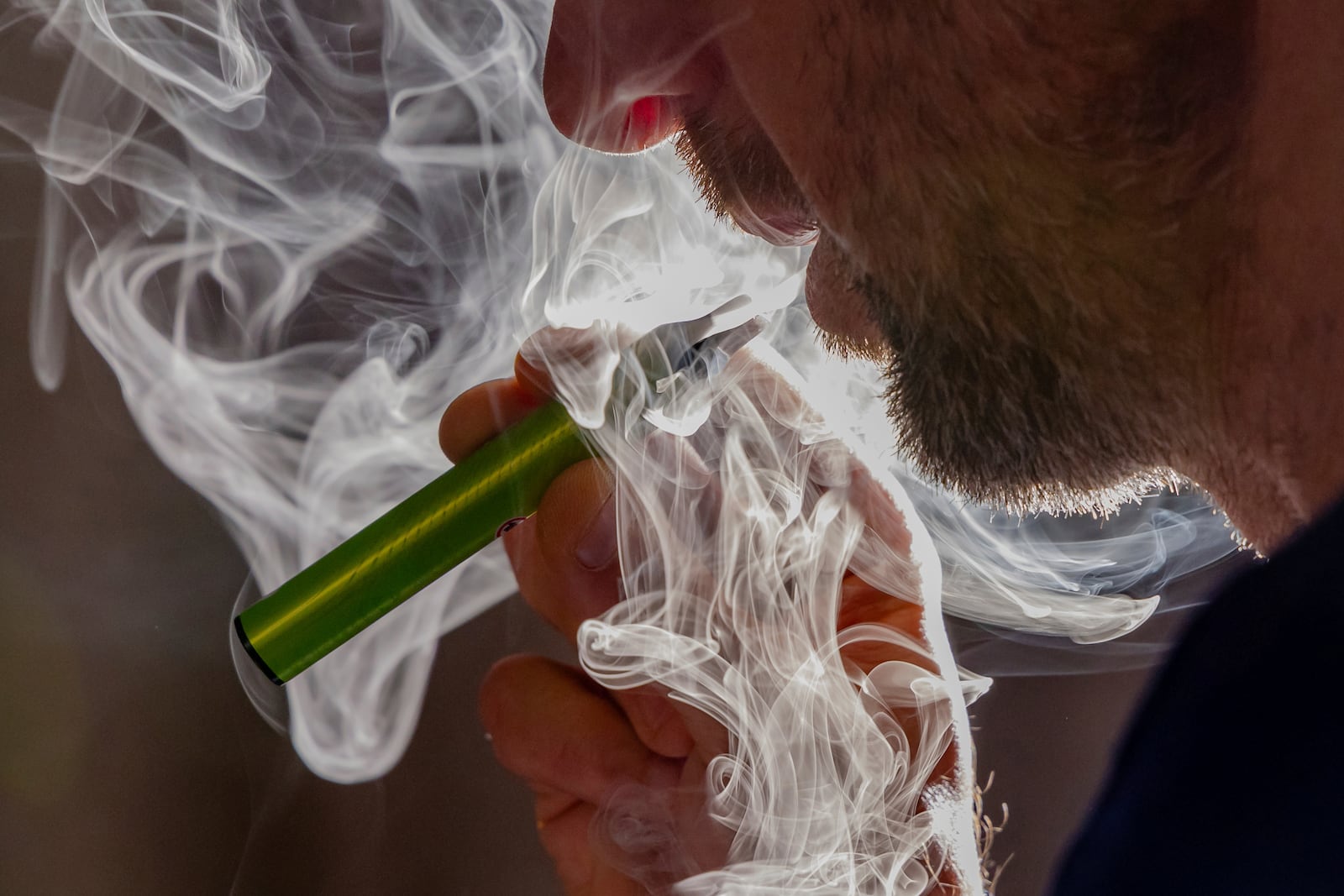 A man vapes on a disposable electronic cigarette in Brussels on Dec. 12, 2024, ahead of Belgium's ban on the sale of disposable vapes as of Jan. 1, 2025. (AP Photo/Geert Vanden Wijngaert)