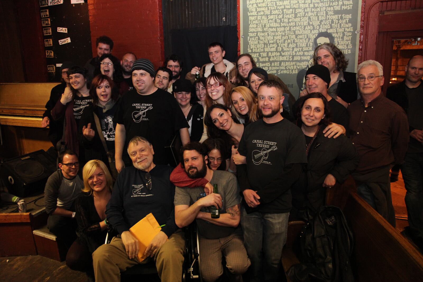 Mick Montgomery surrounding by former employees at the closing of Canal Street in 2013.