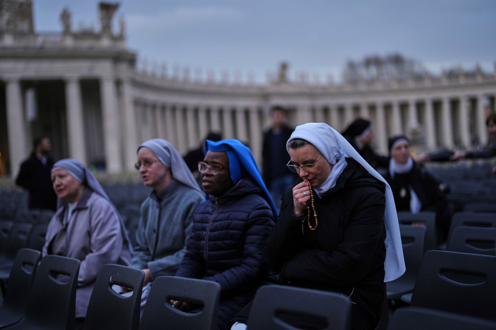 Nuns pray during a Rosary prayer for Pope Francis, in St. Peter's Square at the Vatican, Tuesday, March 11, 2025. (AP Photo/Francisco Seco)