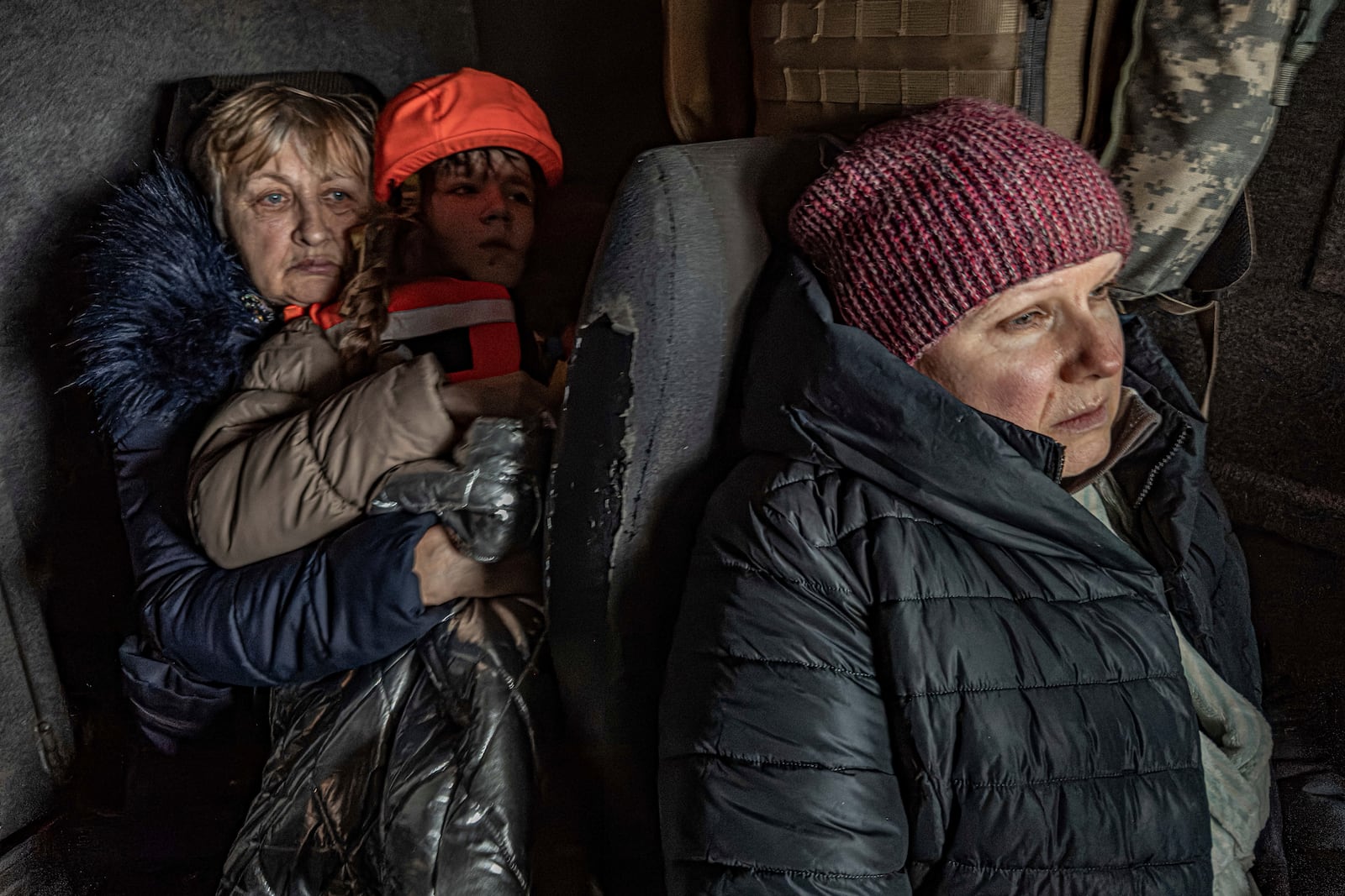 Katia, 11, with her grandmother and mother sit in an armoured minivan during en evacuation by the "White Angels" police unit in Kurakhove, Donetsk region, Ukraine, on Nov. 4, 2024. (AP Photo/Anton Shtuka)