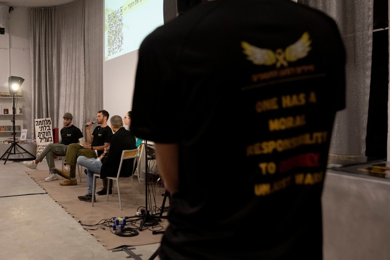 Yuval Green, center, and Yotam Vilk, left, take part in a panel discussion for soldiers refusing to serve in the Gaza Strip, in Tel Aviv, Israel, on Tuesday, Jan. 7, 2025. (AP Photo/Maya Alleruzzo)